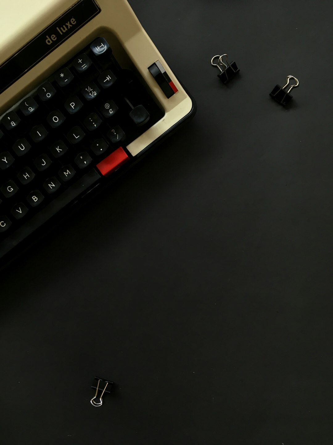 Vintage typewriter with a notebook and fountain pen on a wooden desk